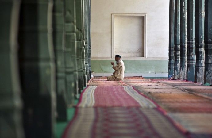 A Ugyhur Muslim worshiper prays inside the Kashgar Idgah mosque